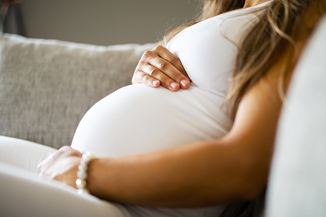 Pregnant woman holding belly