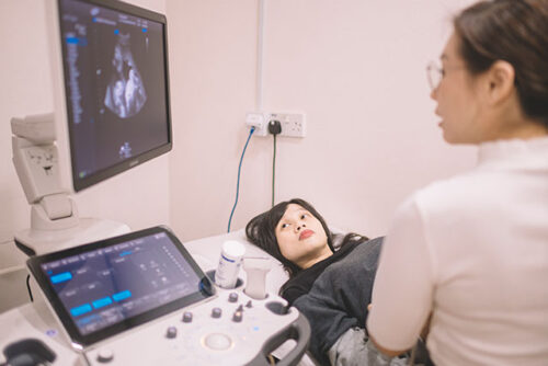 woman and doctor looking at ultrasound