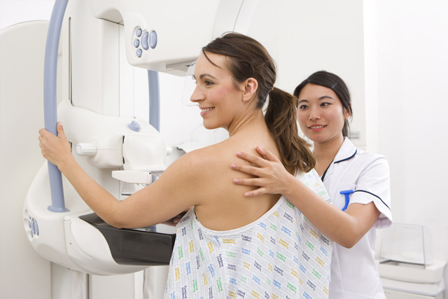 Woman getting a mammogram screening from her doctor.
