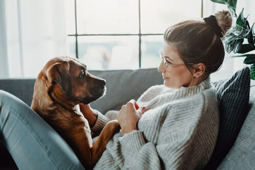 A woman sitting with dog.