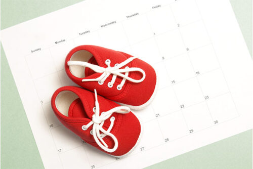 baby shoes on top of calendar