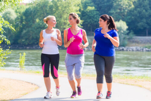 Three people talking and getting ready to go for a run as part of their exercise routine.