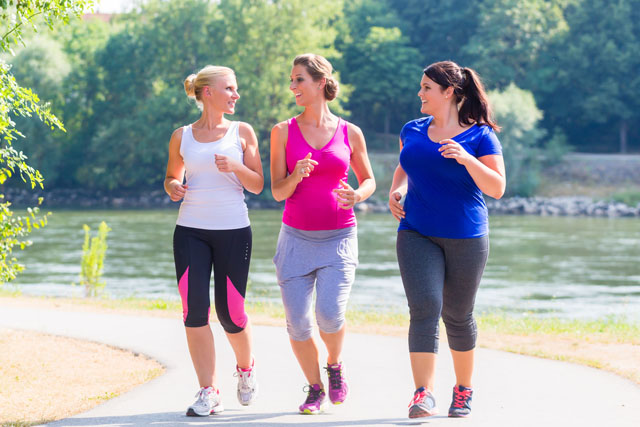 Three people talking and getting ready to go for a run as part of their exercise routine.