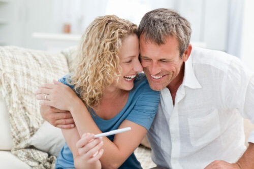 A couple hugging each other and laughing.