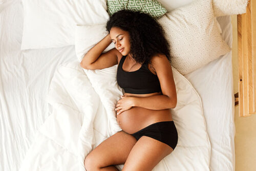 pregnant woman asleep in bed