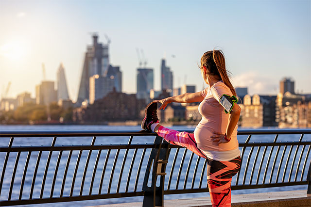 pregnant woman stretching for a run