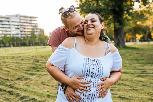 pregnant couple embracing