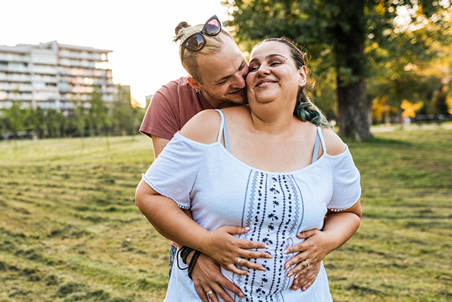 pregnant couple embracing