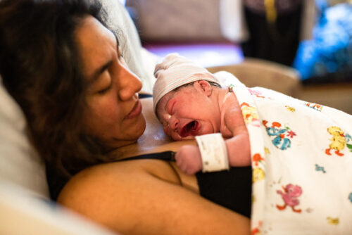 Mother in hospital bed with newborn