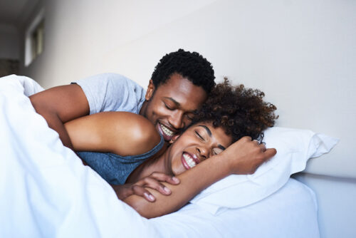 Couple cuddling in bed