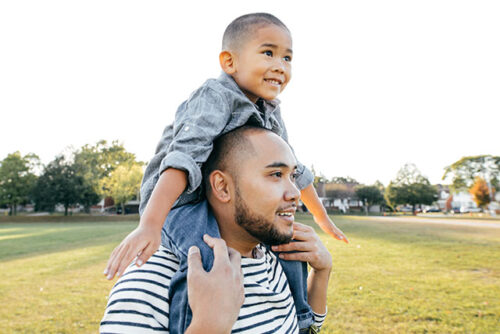 toddler on dads shoulders