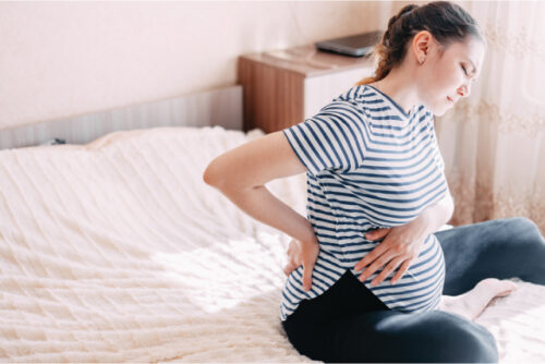 Pregnant woman experiencing back pain/cramps