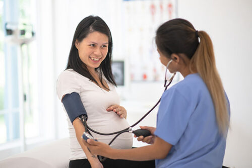 pregnant woman gets blood pressure checked