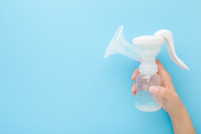 woman holding breast pump