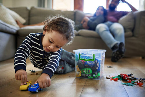 toddler playing with toy cars