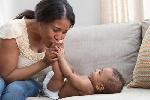 mom kissing baby's feet
