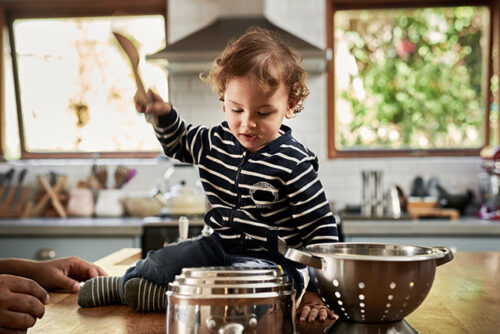 toddler banging on pots and pans