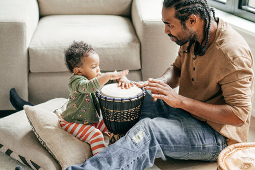baby and dad playing drums