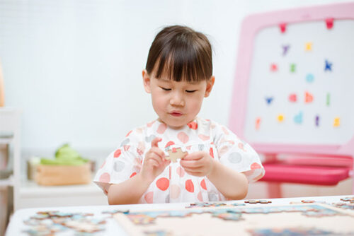 toddler working on puzzle