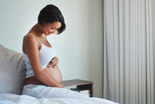 pregnant woman holding stomach