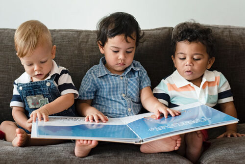 three toddlers on couch