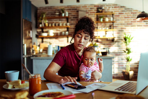 new mom working at kitchen table