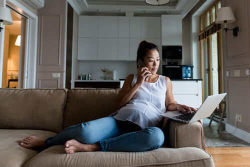 woman on computer and phone