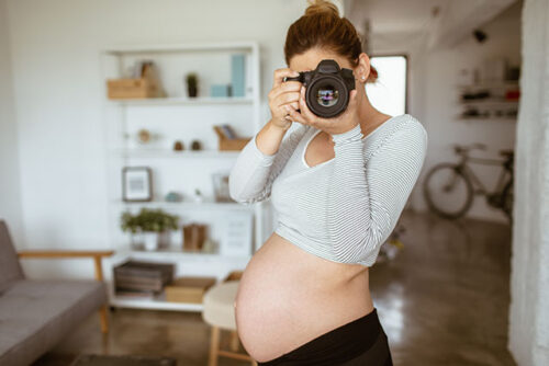 pregnant woman taking selfie