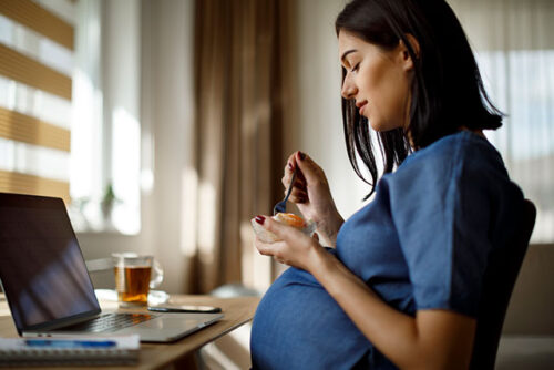 pregnant woman eating fruit