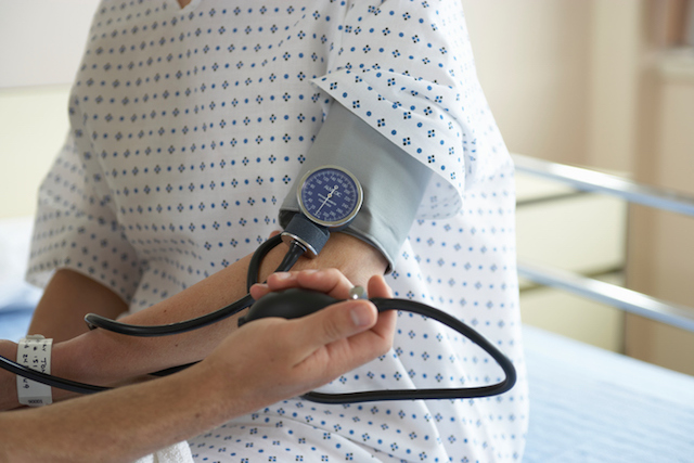 Image of person getting their blood pressure checked at their primary care provider (PCP) appointment.