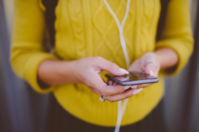 Image of a person checking their phone.