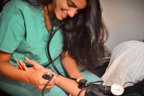 A primary health provider giving their patient an examination.