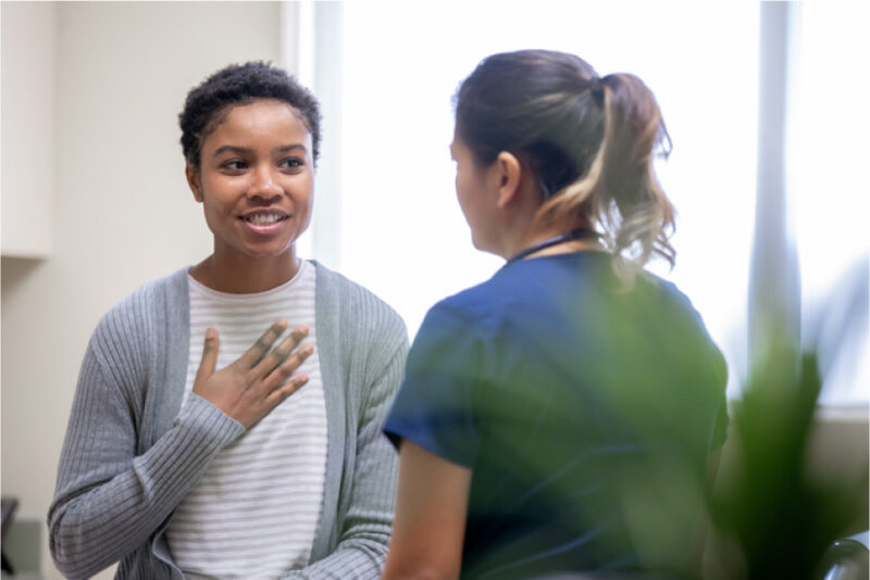 A woman speaking with healthcare provider.