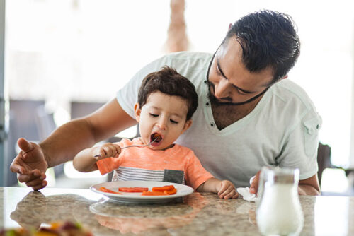 dad with toddler eating