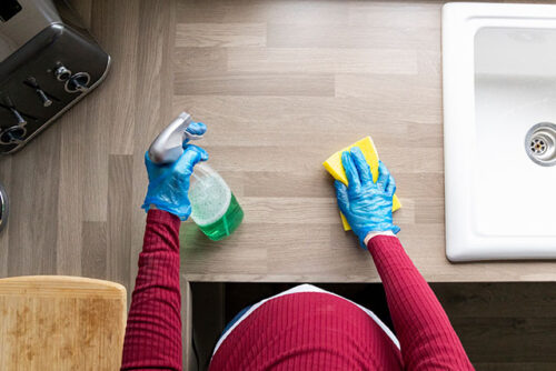 pregnant woman cleaning counter