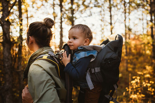 mom carrying toddler in carrier
