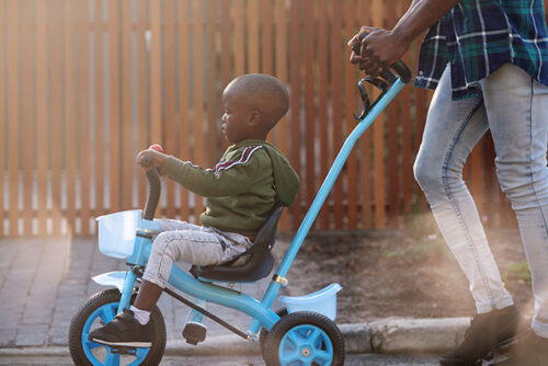 toddler on tricycle