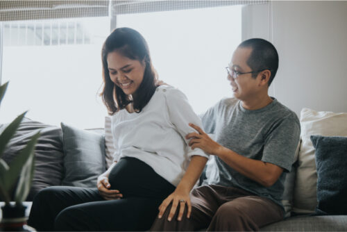 Husband giving back rub to pregnant wife