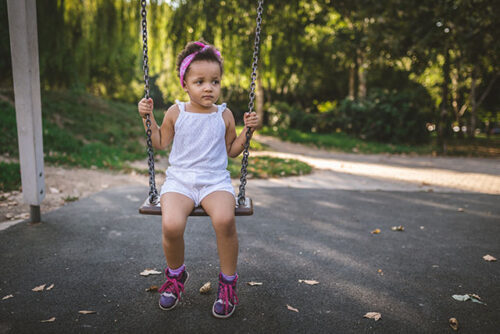 toddler on swing set