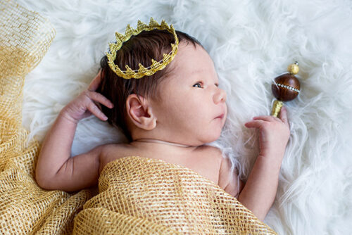 Can you spoil a baby? Image here is of a baby wearing a crown and holding a scepter to represent this question.