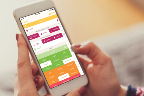 A person using an app on their phone as a fertility tracker