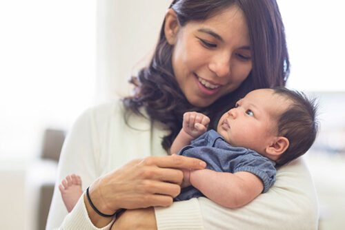mom holding baby