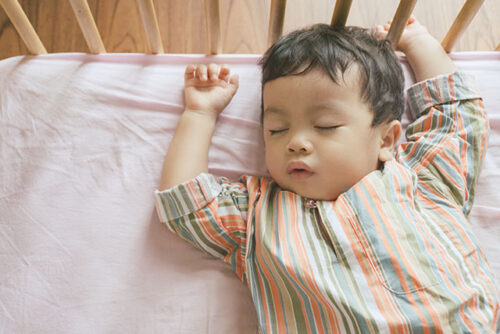 baby asleep in crib