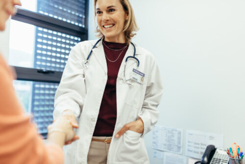 Person shaking the hand of their new healthcare provider.