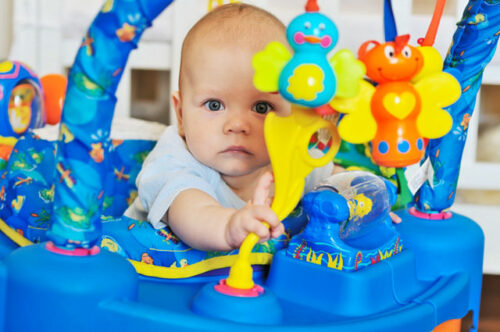 A baby in a walker, one of the dangerous household items for babies that people don't know about.