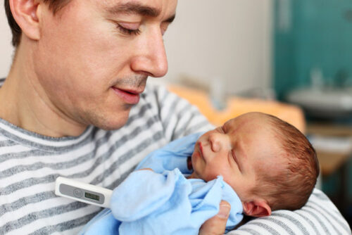 A baby in their parent's arms.