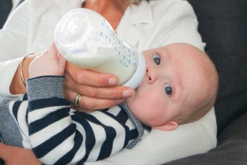 A person feeding their baby breast milk.