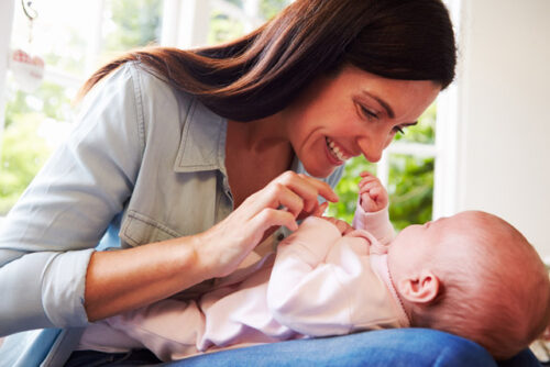 A person playing with their baby.