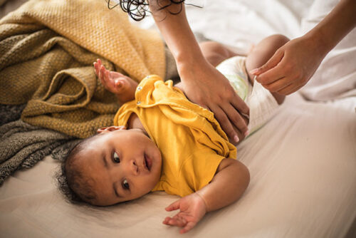 A baby getting diaper changed to represent managing diaper rash.