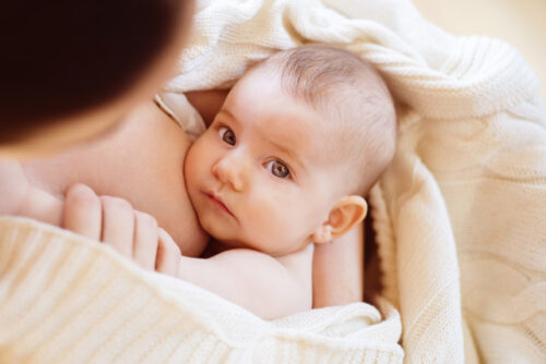 A baby about to breastfeed.